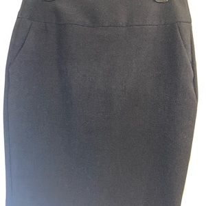 Black petite women’s skirt with pockets and slit in back.